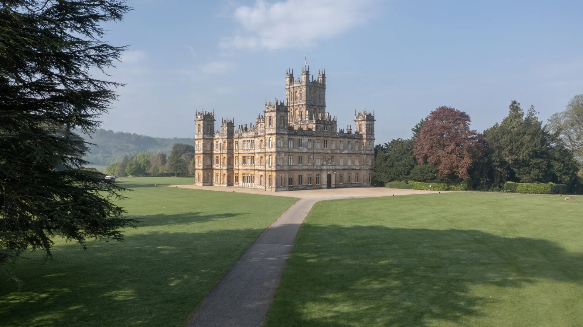 Highclere Castle at golden hour, surrounded by parkland